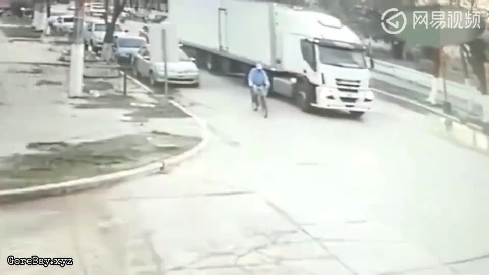 Man rides a bicycle into a truck's blind spot as it makes turn and get wiped 4