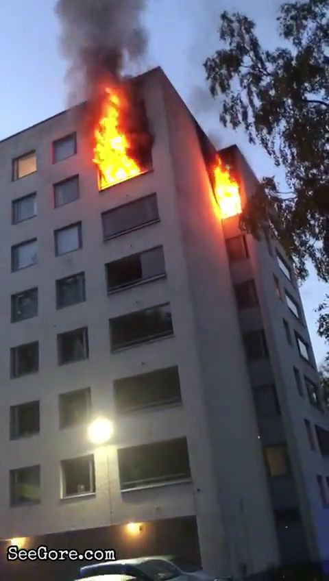 A man jumping from a burning apartment a few stories high 1