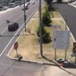 Road repaving has traffic reversed and a man crossing the street forgets that 1