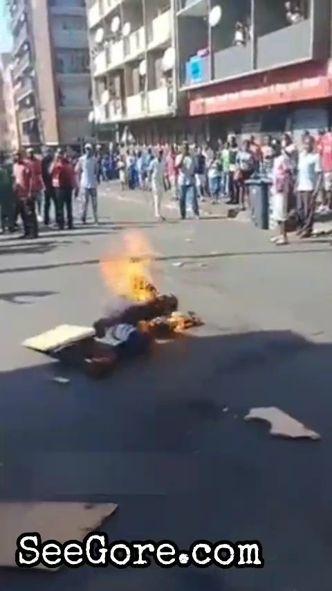 Crowd watches a man being burned alive 10
