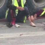 Woman with a torn foot grieving next to her crushed partner 2
