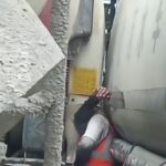 Man Stuck Between Trucks 1