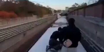 A Group of Men Risking Their Life on a Moving Train 17